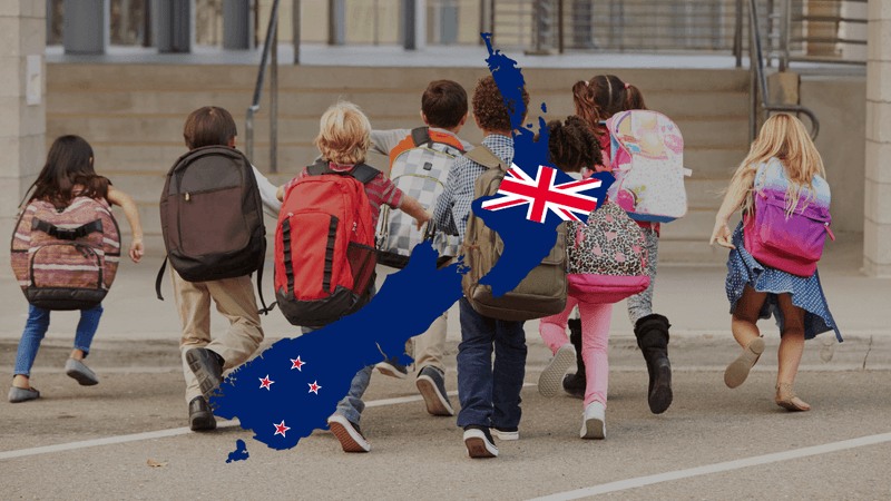 Family with children moving to New Zealand - parents and kids walking on beach with mountains in background